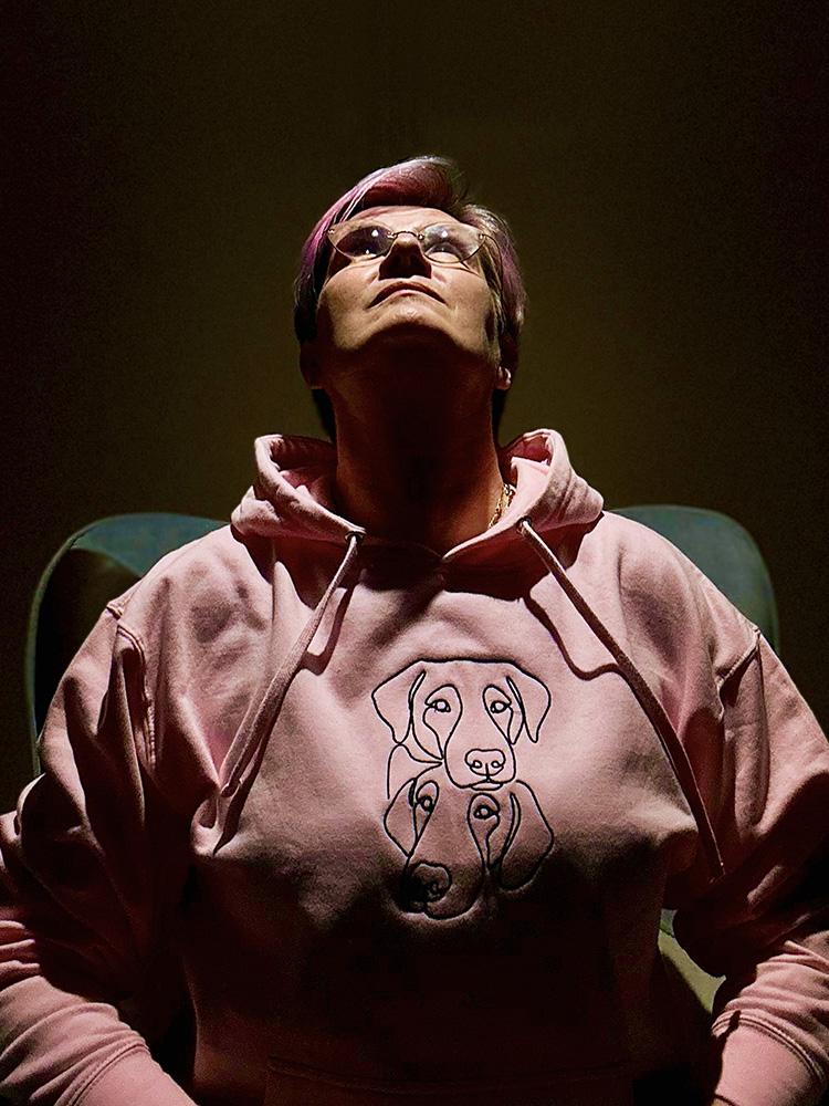 Andrea wearing the two dogs hoodie of the iconic collection